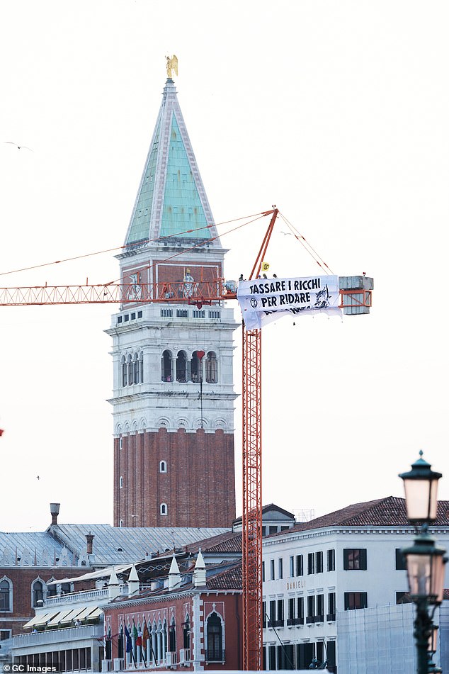 Extinction Rebellion" activists protest under the slogan "Tassare I Ricchi Per Ridare Al Pianeta" (Taxing the Rich to Give Back to the Planet) against the wedding of Jeff Bezos and Lauren Sanchez