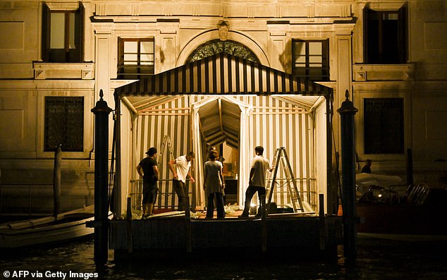 Workers set up a footbridge late in the night at the entrance of the luxury hotel Aman, on June 24, 2025, in Venice ahead of the three-day wedding party of Amazon tycoon Jeff Bezos and Lauren Sanchez