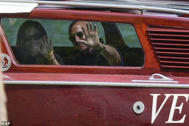 The pair waved to paparazzi as they steamed through Venetian waterways