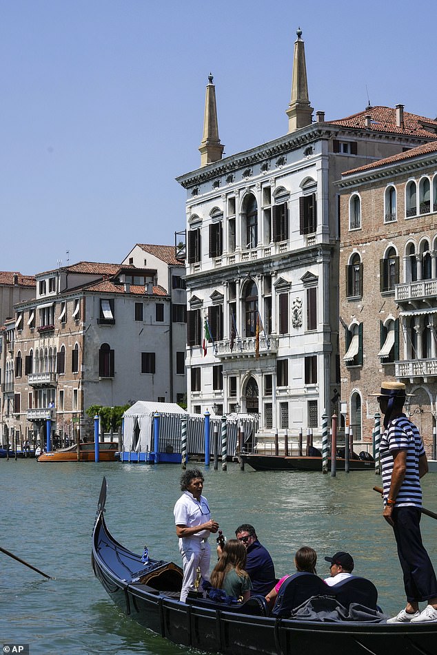 The Aman hotel has built a private jetty for the lucky 48 guests who will be staying there for the Bezos wedding. Pictured: A gondola carries tourists in front of the Aman Hotel along the Grand Canal in Venice, Italy, on Wednesday, June 25, 2025, ahead of festivities in the lagoon city reportedly linked to a wedding celebration for Jeff Bezos and Lauren Sanchez