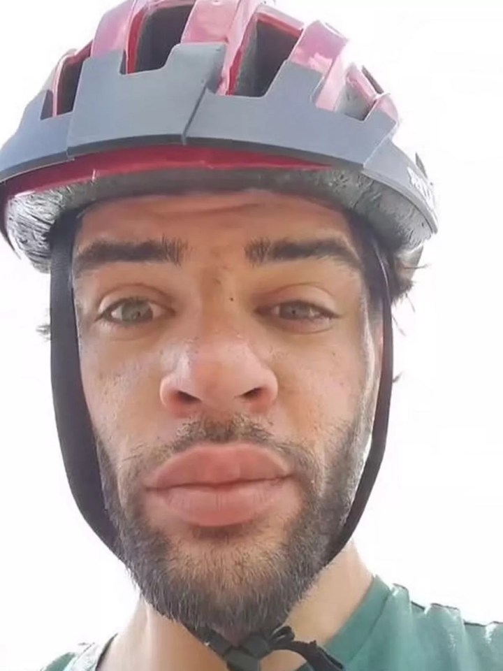 Close-up of a man wearing a bicycle helmet.