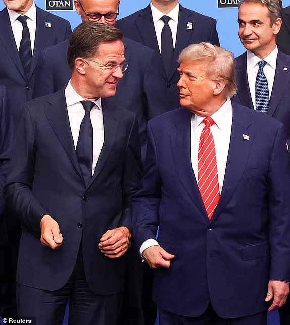 U.S. President Donald Trump talks with NATO Secretary General Mark Rutte, as they pose for a family photo during a NATO leaders summit in The Hague, Netherlands June 25, 2025. REUTERS/Yves Herman