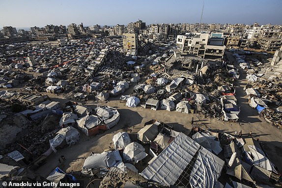 GAZA CITY, GAZA - JUNE 24: A general view of the makeshift tents housing Palestinians and buildings destroyed in Israeli attacks as deprived of basic needs such as shelter, food and clean water, Palestinians struggle to survive in difficult living conditions in the Sheikh Ridvan neighborhood of Gaza City, Gaza on June 24, 2025. The humanitarian crisis experienced by Gazans trying to survive in tents or on the rubble of collapsed buildings is escalating day by day due to Israel's attacks and blockade. (Photo by Mahmoud Issa/Anadolu via Getty Images)