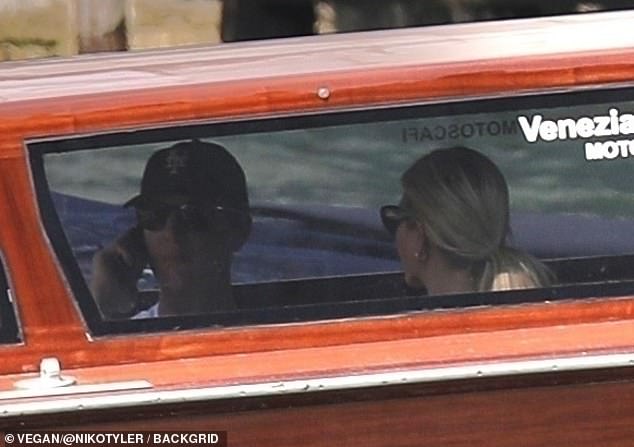 The mother-of-three looked chic in a white, patterned sun dress that contained a tight bodice and strappy sleeves, leaving her toned shoulders on full display