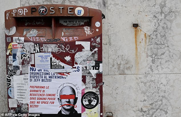 This picture taken on June 24, 2025 shows a poster calling for a protest against Bezos' wedding pasted on a mail box in Venice