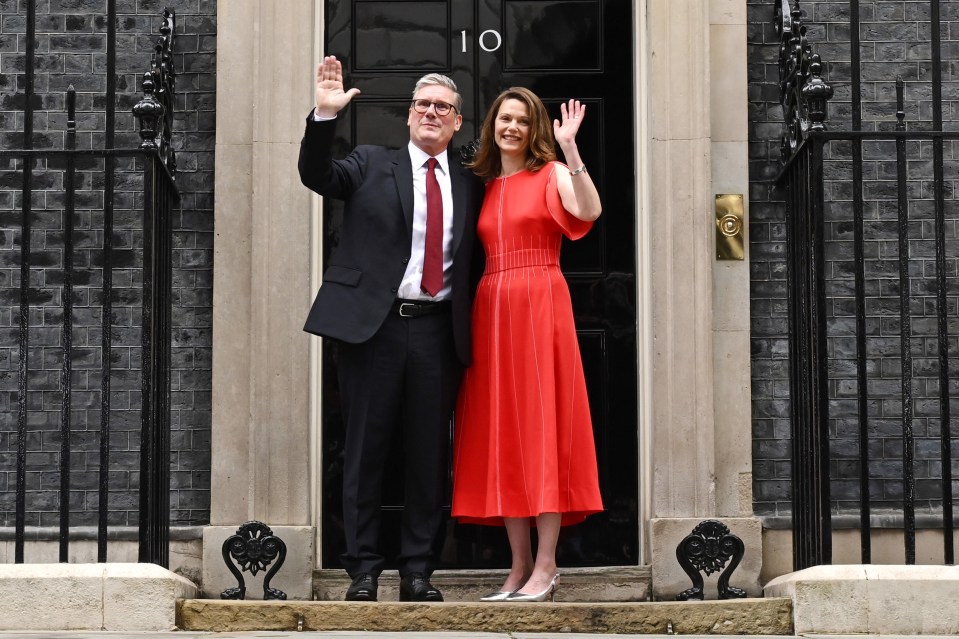 Keir Starmer and his wife waving outside 10 Downing Street.