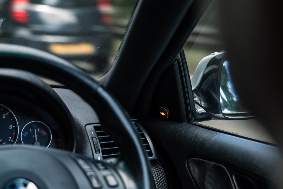 Car's interior with illuminated warning light.