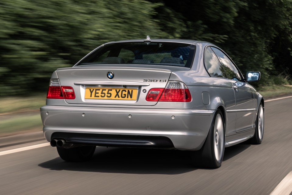 Silver BMW 330Ci driving on a road.