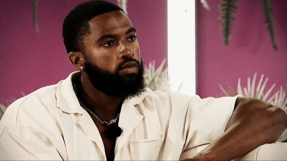 Man with beard sitting on a couch.