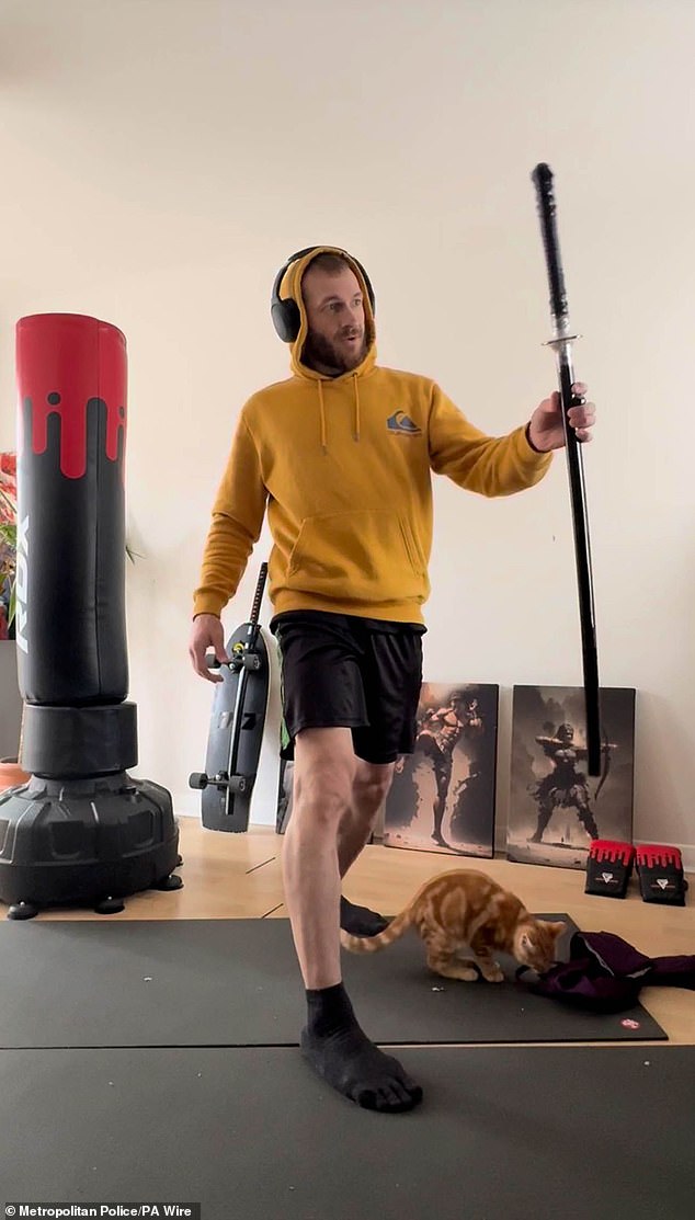 Monzo filmed himself unwrapping the sword he later used to kill Daniel Anjorin. Also in this image is his cat, Wizard, who he strangled, skinned and de-boned because he became convinced the pet would be the architect of Armageddon