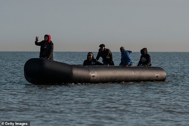 A man gestures from a migrant dinghy on June 17, 2025 in Gravelines, France