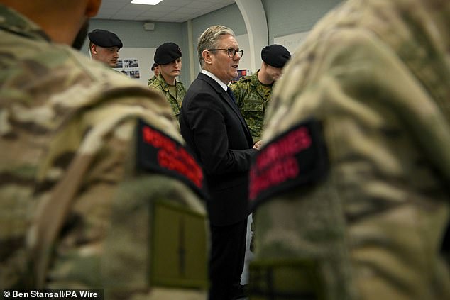 Sir Keir Starmer talks to soldiers during a visit to the Netherlands marines training base during a NATO summit visit at the Hague