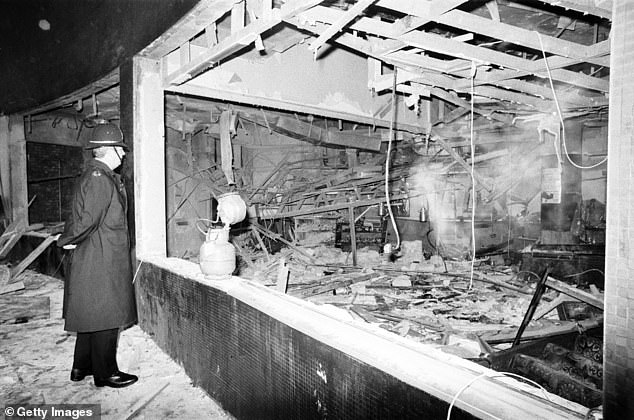 Pictured: A fireman searches through the wreckage of the Mulberry Bush pub underneath the Rotunda in Birmingham City Centre believed to have been caused by a bomb attributed to the IRA
