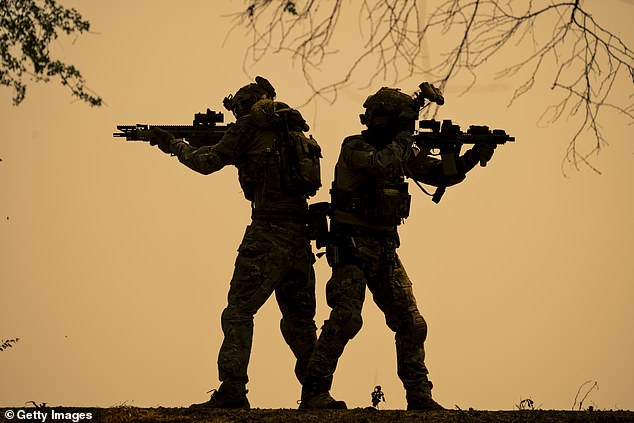 A silhouette of two special armed forces soldiers standing behind one another (file image)