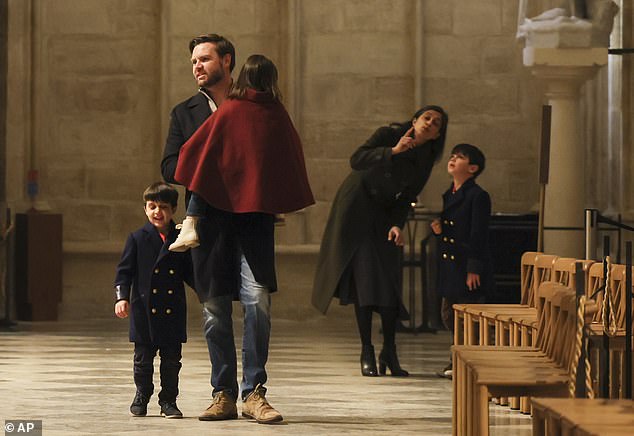 Vice President J.D. Vance (left) carries Mirabel and holds the hand of son Vivek, while Usha Vance (right) shows her son Ewan the ceiling of the Notre Dame in Paris, France in February