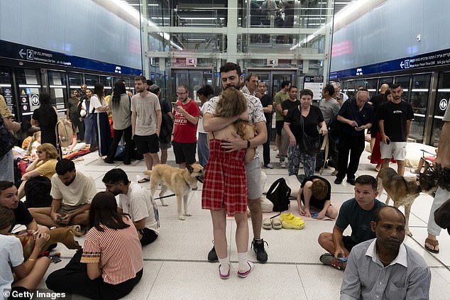 People take cover in an underground train station transformed into a public shelter following reports of an incoming missile fired from Iran, on 18, 2025 in Ramat Gan, Israel