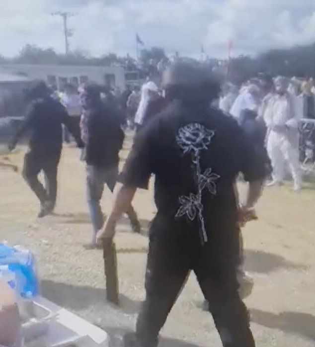 As the atmosphere turned ugly, festival-goers pulled out weapons such as guns, machetes and ceremonial swords to fight with. One man was shot in the groin in chaotic scenes