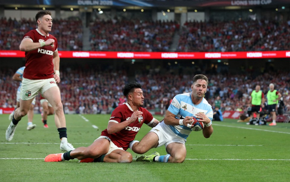Argentina's Santiago Cordero scores a try during a rugby match.