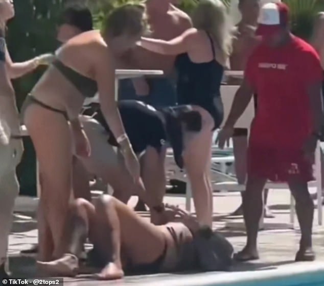 The woman was left lying motionless on the ground as multiple bystanders attended to her