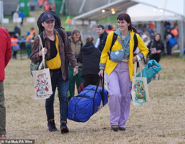 A rain shower at Worthy Farm in Somerset this morning as revellers arrive for Glastonbury