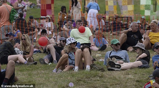 People with balloons in their mouths at Glastonbury Festival in Somerset yesterday evening