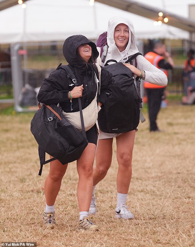 A rain shower at Worthy Farm in Somerset this morning as revellers arrive for Glastonbury