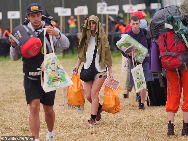 A rain shower at Worthy Farm in Somerset this morning as revellers arrive for Glastonbury