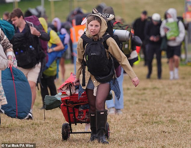 A rain shower at Worthy Farm in Somerset this morning as revellers arrive for Glastonbury