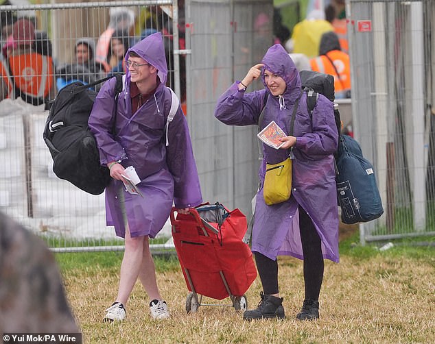 A rain shower at Worthy Farm in Somerset this morning as revellers arrive for Glastonbury
