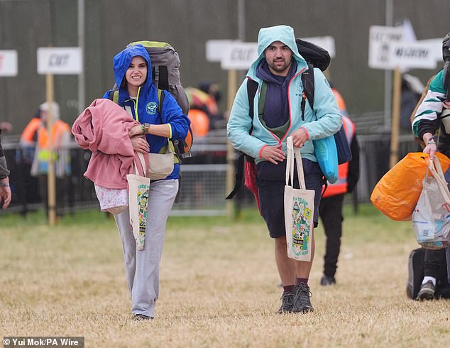 A rain shower at Worthy Farm in Somerset this morning as revellers arrive for Glastonbury