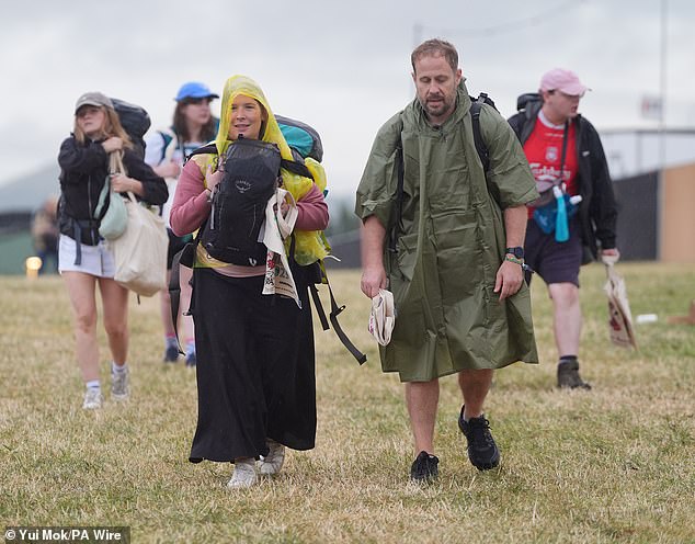 A rain shower at Worthy Farm in Somerset this morning as revellers arrive for Glastonbury