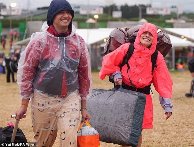 A rain shower at Worthy Farm in Somerset this morning as revellers arrive for Glastonbury