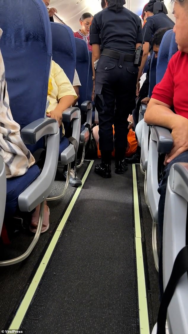 He requested to be transferred to the emergency exit seat, which had more leg room, but allegedly threw a tantrum when flight attendants refused to grant his request. Video grab shows the man lying on the floor in protest after airline staff tried to get him off the plane