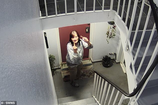 Gray, who lived below the couple in their Wandsworth flat, seen showing her middle fingers up