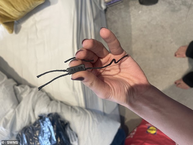 Pictured: A Reiss label that the couple claim was left cut out from their order which was found under the stairs in a Lidl bag