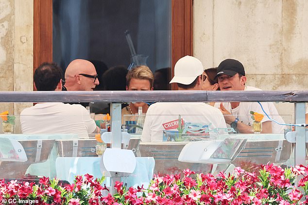 Cheersing drinks and tucking into a spread of food, the friends sat and laughed around a large table