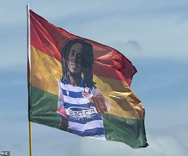 A fourth flag shows Bob Marley in front of a rainbow coloured flag wearing a Reading football kit, with his hand reaching out