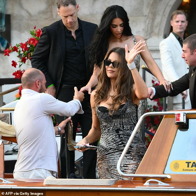 Khloe Kardashian joined her, donning a silver and black gown that accentuated her stunning curves