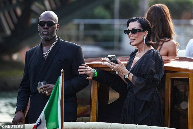 Their mom Kris Jenner opted for a chic black dress with flowing, quarter length sleeves. She was joined by her longtime beau Corey Gamble, who matched her in an all-black suit