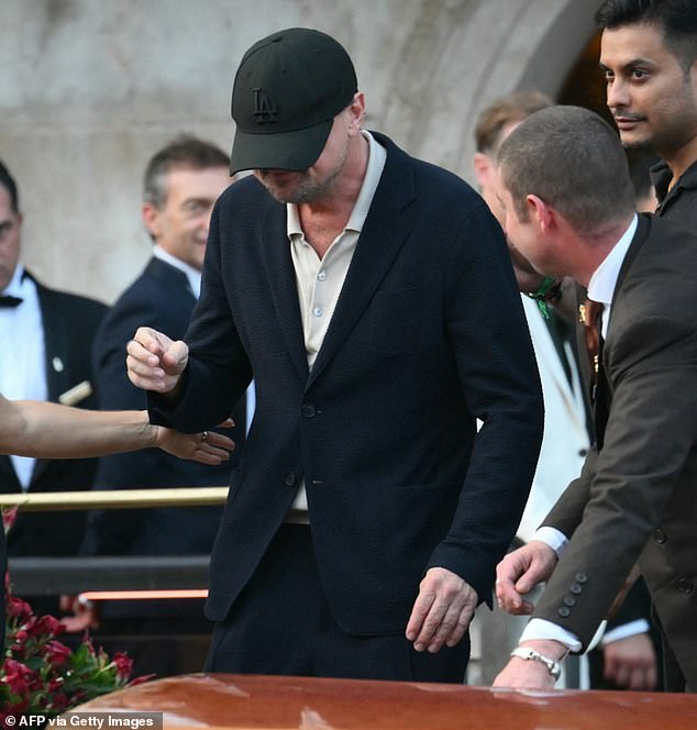 Leonardo DiCaprio tried to keep a low profile by wearing a black cap that covered his entire face