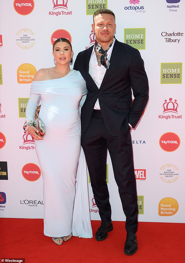 She added inches to her height with a pair of silver open-toe heels and toted her essentials in a silver clutch
