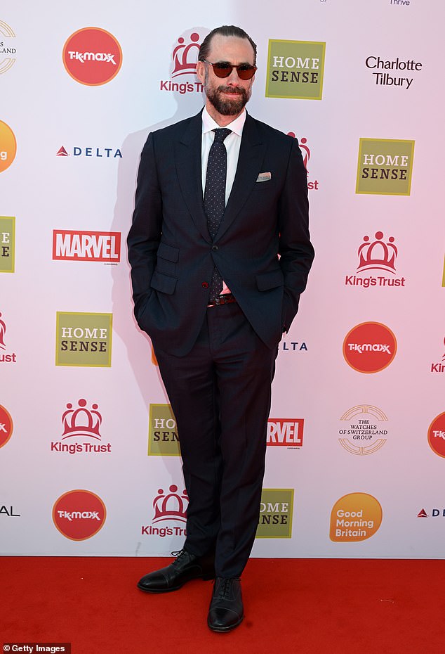 Actor Joseph Fiennes looked incredibly dapper in a navy blue blazer and black tailored trousers