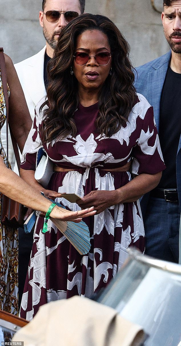 Cool for the summer! Oprah looked great on Thursday evening as she got into a water taxi in a dark maroon and white patterned dress. The frock included cut-outs at the sides, and she tied together the look with a pair of chic, round glasses