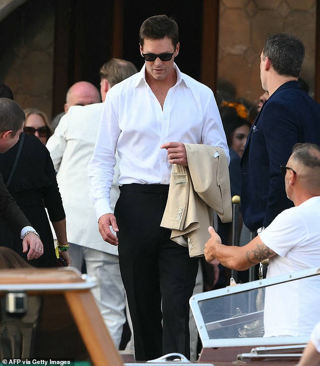 Tom Brady looked especially handsome on Thursday as he kept things simple and casual-cool in a white button-down dress shirt and black pants. He wore a pair of black sunglasses to protect his eyes from the Venice heat, and draped a khaki-colored blazer around his arm. His appearance at the wedding comes just a few months after his ex-wife, Gisele Bündchen, welcomed a baby with partner Joaquim Valente