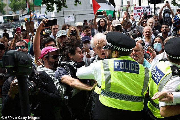 Protestors clash with MET police officers during a rally in support of pro-Palestinian group Palestine Action after British government announced the group's ban, in Trafalgar Square, in central London, on June 23, 2025