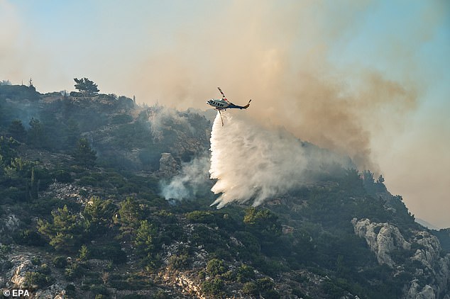 A firefighting helicopter in action during wildfire operations on Chios Island