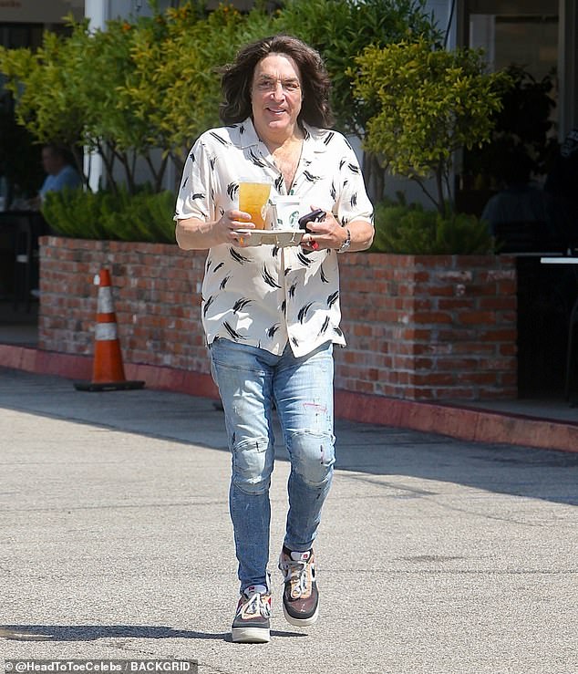 The rocker, now 73, kept it low-key in a casual polo shirt and faded jeans, a far cry from the wild makeup and outlandish costumes he once wore as the face of KISS