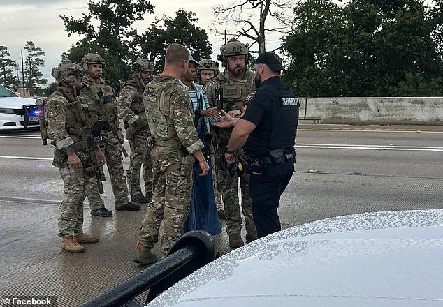 Pictures showed the woman, wearing all blue, as she was escorted off the road by at least eight authorities