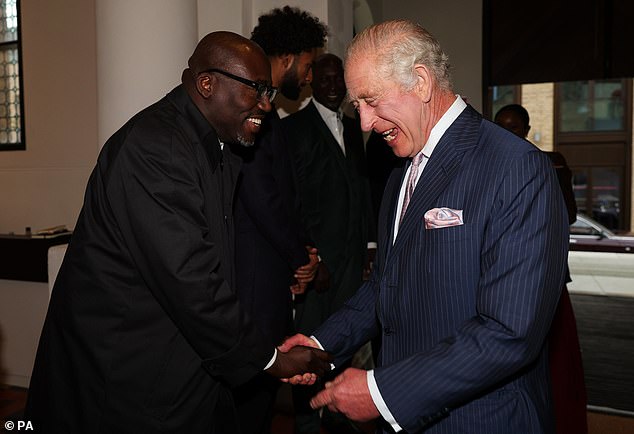 King Charles III (right) shakes hands as he welcomes Edward Enninful during a reception and discussion to learn about opportunities for young people in October 2023