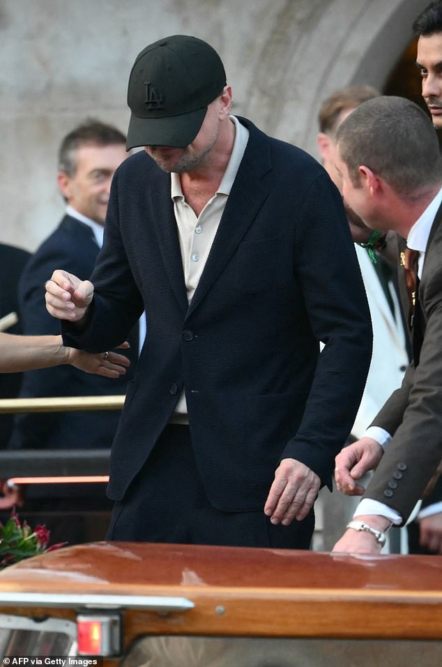 Leonardo, 50, looked skinny as he sported a black suit over a beige polo shirt